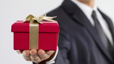 iStock_000019052230XSmall-Business-Man-Holding-Gift
